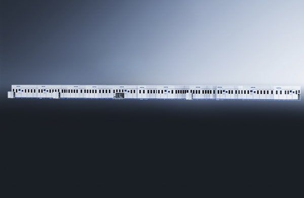 The קו הרכבה לתאי סוללה is displayed in profile, featuring a sleek, modern white and blue design with multiple connected cars, windows, and doors visible against a gradient gray-to-black background.