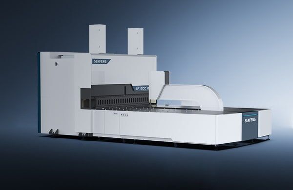 A large, modern industrial machine labeled דגם BDC 3200 with a sleek white and gray design stands against a gradient blue background, featuring a prominent horizontal section and two vertical components.