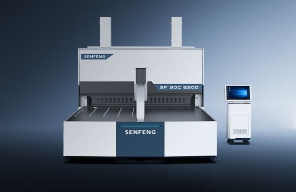 A large industrial דגם BDC 3200 machine stands on a plain floor, with a separate control unit featuring a monitor and keyboard to the right, both set against a gradient blue backdrop.