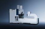 The דגם BDC 2500 is a large, modern industrial machine with a white and gray exterior. It features vertical and horizontal components and is displayed on a plain, gradient blue background.