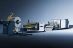 The דגם 1503CLH is a modern industrial metal processing machine featuring a large roll of sheet metal, conveyors, and automated cutting units, set against a gradient blue background.