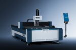 The דגם 3015NP is a large industrial SENFENG laser cutting machine featuring a flat work surface and attached control panel, displayed against a gradient blue-gray background.