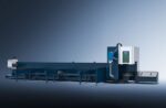 The דגם 6012 PLUS is a large industrial CNC machine with a long blue base and white control unit, designed for cutting or machining metal pipes or tubes, shown against a gradient blue background.