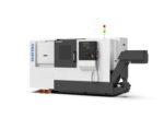 The SENFENG דגם SF-TCK50 is a large industrial CNC machine featuring a control panel, door, and conveyor system, all supported on a black base with orange blocks underneath.