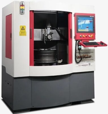 A large industrial CNC machine with a red and white exterior, a window showing internal parts, and a touchscreen control panel with buttons and a keyboard on the right side.