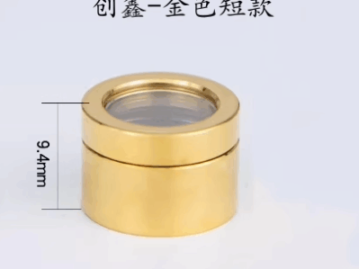 A small, cylindrical חלון מגן MAX 12.8*9.4 in gold color, measuring 9.4mm high and 12.8mm in diameter, sits on a light background with black Chinese text above it.