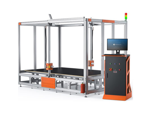 A large industrial machine with a metal frame, flat working surface, control panel, and a computer monitor running Windows 10, used for automated manufacturing or processing tasks.