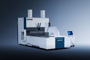 The industrial דגם BDC 2500 machine, with a control panel and monitor and a sleek white and blue design, stands on a plain gradient blue background.